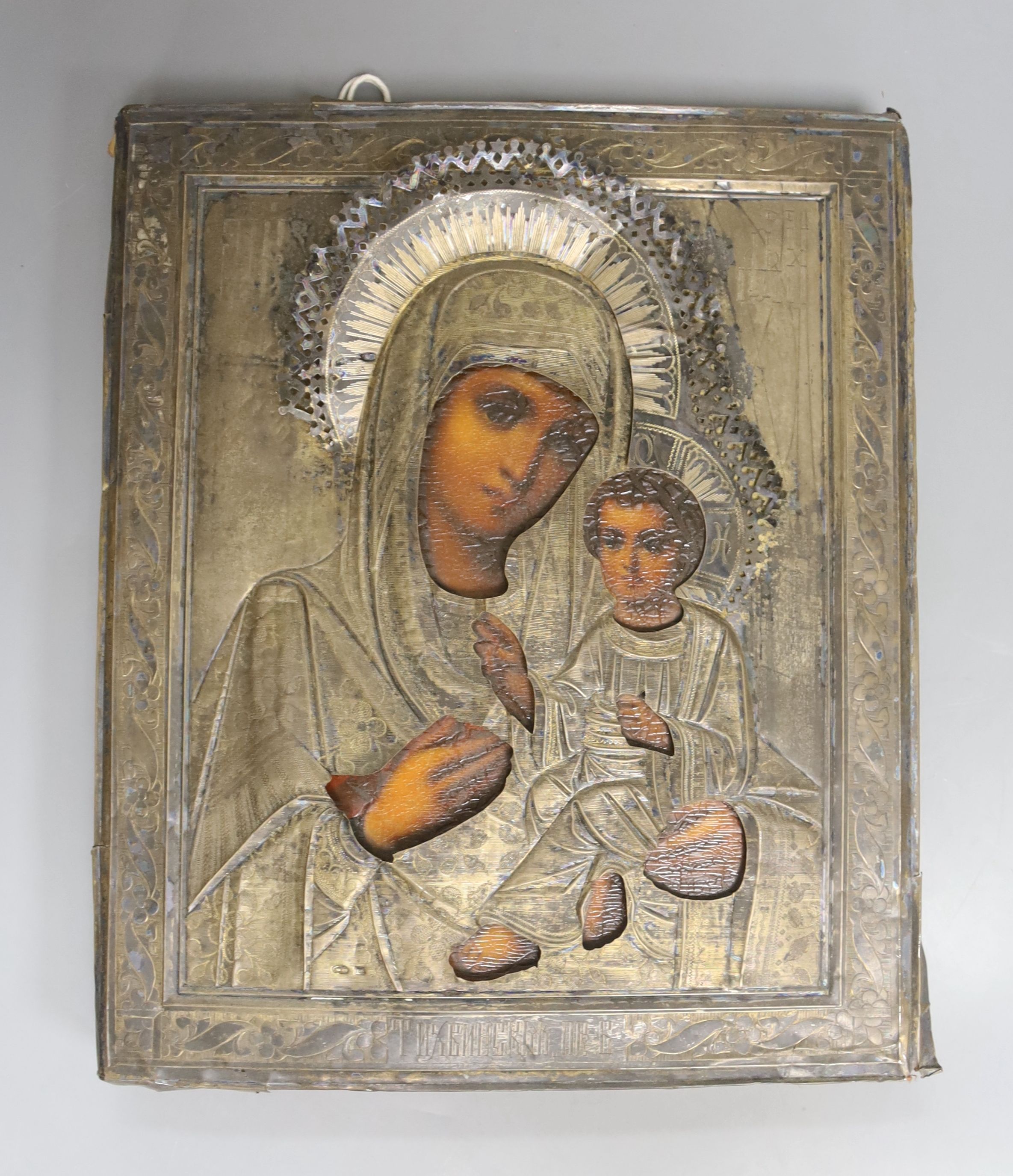 A 19th century Russian 84 zolotnik Icon depicting the Madonna and child, pierced apertures with painted details, 27 x 23cm
